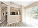Open dining area features a pass-through to the kitchen, modern gray flooring, and a sliding door to backyard at 1311 Flintlock Dr, Greenwood, IN 46143