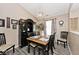 Traditional dining room with black wood table, chairs, cabinet, and accent lighting at 1311 Flintlock Dr, Greenwood, IN 46143