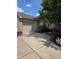 Long driveway to a two-car garage, brick and vinyl siding with mature trees at 1311 Flintlock Dr, Greenwood, IN 46143