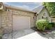 Spacious attached garage featuring brick facade, and a convenient driveway at 1311 Flintlock Dr, Greenwood, IN 46143