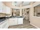 Modern kitchen featuring white cabinetry, black countertops, and wood-look flooring at 1311 Flintlock Dr, Greenwood, IN 46143