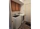 Laundry room with washer, dryer, overhead cabinets, and door at 1311 Flintlock Dr, Greenwood, IN 46143