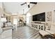 Open concept living room with vaulted ceilings, wood-look floors, and neutral paint at 1311 Flintlock Dr, Greenwood, IN 46143