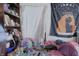 Interior shot of a disorganized bedroom with a bookshelf and astrology tapestry at 1325 N Gavin St, Muncie, IN 47303