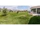 Expansive backyard boasts meticulously manicured lawn with mature trees at 13427 Merryvale St, Fishers, IN 46037