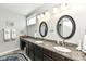 Bathroom with dual sinks, granite counters, and elegant lighting at 13427 Merryvale St, Fishers, IN 46037
