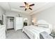 Comfortable bedroom featuring a large bed, closet doors, and an en suite bathroom at 13427 Merryvale St, Fishers, IN 46037
