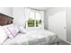 Bright bedroom featuring a large window, plush bedding, and closet with sliding doors at 13427 Merryvale St, Fishers, IN 46037
