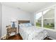 Bright bedroom with wood floors, light-colored walls, and large window overlooking yard at 13427 Merryvale St, Fishers, IN 46037