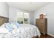 Comfortable bedroom with wood floors, large window, and natural light at 13427 Merryvale St, Fishers, IN 46037