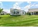 Exterior view of home shows a sunroom and large yard at 13427 Merryvale St, Fishers, IN 46037