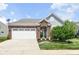 Charming single-story home featuring brick accents, a two-car garage, and a well-manicured front yard at 13427 Merryvale St, Fishers, IN 46037