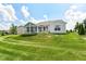 Exterior view of home shows a sunroom and large yard at 13427 Merryvale St, Fishers, IN 46037