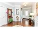 Inviting foyer with hardwood floors, decorative mirror, and elegant details at 13427 Merryvale St, Fishers, IN 46037