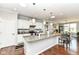 Modern kitchen features a granite island, stainless appliances, and pendant lighting at 13427 Merryvale St, Fishers, IN 46037