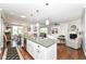 Open-concept kitchen with granite island seamlessly connects to living and dining areas at 13427 Merryvale St, Fishers, IN 46037