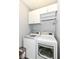 Bright laundry room featuring a modern washer and dryer set with white cabinets above at 13427 Merryvale St, Fishers, IN 46037