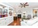 Inviting living room featuring a fireplace, built-in bookcase, and hardwood floors at 13427 Merryvale St, Fishers, IN 46037