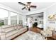 Bright and airy living room featuring hardwood floors, neutral decor, and a view to dining area at 13427 Merryvale St, Fishers, IN 46037