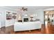 Spacious living room with a fireplace, built-in shelving, and hardwood floors at 13427 Merryvale St, Fishers, IN 46037