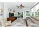 Comfortable living room with modern furniture, access to sunroom, and plenty of natural light at 13427 Merryvale St, Fishers, IN 46037
