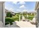 Outdoor patio with seating overlooks the landscaped backyard at 13427 Merryvale St, Fishers, IN 46037