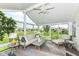 Bright sunroom with vaulted ceilings, ceiling fan, and panoramic views at 13427 Merryvale St, Fishers, IN 46037