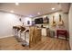 This finished basement offers a bar with seating, lighting and decor, plus a rustic wood and white finish at 14404 Stairbridge Pl, Carmel, IN 46074