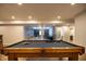 Well-lit basement featuring a full-size pool table with a view of the cozy media room with a projector at 14404 Stairbridge Pl, Carmel, IN 46074