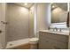 Modern bathroom featuring a tiled shower, vanity with backlit mirror, and contemporary fixtures at 14404 Stairbridge Pl, Carmel, IN 46074