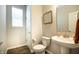 Half bathroom featuring a pedestal sink, modern fixtures, and neutral decor at 14404 Stairbridge Pl, Carmel, IN 46074