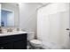 This bathroom features a black vanity cabinet, white countertop and toilet next to a tub shower combo with curtain at 14404 Stairbridge Pl, Carmel, IN 46074