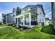 Charming two-story home featuring a covered porch, manicured lawn, and lush landscaping at 14404 Stairbridge Pl, Carmel, IN 46074