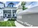 Close up front exterior showcasing the house number and covered porch entryway with brickwork and greenery at 14404 Stairbridge Pl, Carmel, IN 46074