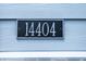 Close up of house number reading '14404' attached to the vinyl siding at 14404 Stairbridge Pl, Carmel, IN 46074
