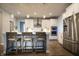 Modern kitchen featuring white cabinets, stainless steel appliances, and a center island with seating at 14404 Stairbridge Pl, Carmel, IN 46074
