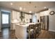 Gourmet kitchen with stainless steel appliances, large center island, and stylish pendant lighting at 14404 Stairbridge Pl, Carmel, IN 46074