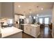 Well-lit kitchen with stainless steel appliances, a kitchen island, and an adjoining dining area at 14404 Stairbridge Pl, Carmel, IN 46074
