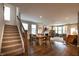 Open floor plan of stairs, dining area, and living room with natural light at 14404 Stairbridge Pl, Carmel, IN 46074