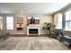 Bright living room featuring recessed lighting, hardwood floors, a cozy fireplace, comfortable seating, and ample natural light at 14404 Stairbridge Pl, Carmel, IN 46074