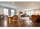 Bright and airy living area with a dining table, a fireplace, and a comfortable rocking chair at 14404 Stairbridge Pl, Carmel, IN 46074