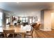 Bright open-concept living and dining area with wood floors, fireplace, and comfortable seating at 14404 Stairbridge Pl, Carmel, IN 46074