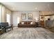 Inviting living room featuring a modern rug, hardwood floors, a cozy fireplace, comfortable seating, and ample natural light at 14404 Stairbridge Pl, Carmel, IN 46074