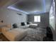 Relaxing media room featuring a large sectional sofa, projector, and custom ceiling lighting at 14404 Stairbridge Pl, Carmel, IN 46074