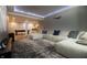 Comfortable media room offering a large sectional, projector, and easy access to other basement amenities at 14404 Stairbridge Pl, Carmel, IN 46074
