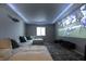 Entertainment space with a large projection screen, comfortable seating, and custom lighting for an immersive experience at 14404 Stairbridge Pl, Carmel, IN 46074