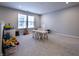 Bright playroom featuring a table and chairs, play kitchen, and comfortable carpeting at 14404 Stairbridge Pl, Carmel, IN 46074