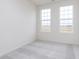 A bright bedroom with two windows, neutral carpet, and ample natural light at 14514 Hanford Ln, Carmel, IN 46074