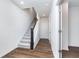 Bright foyer with wood flooring, staircase with carpet runner, and access to other rooms at 14514 Hanford Ln, Carmel, IN 46074