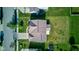 Aerial view of the home's roof, driveway, backyard, landscaping, and neighborhood streets on a bright, sunny day at 14620 Hinton Dr, Fishers, IN 46037